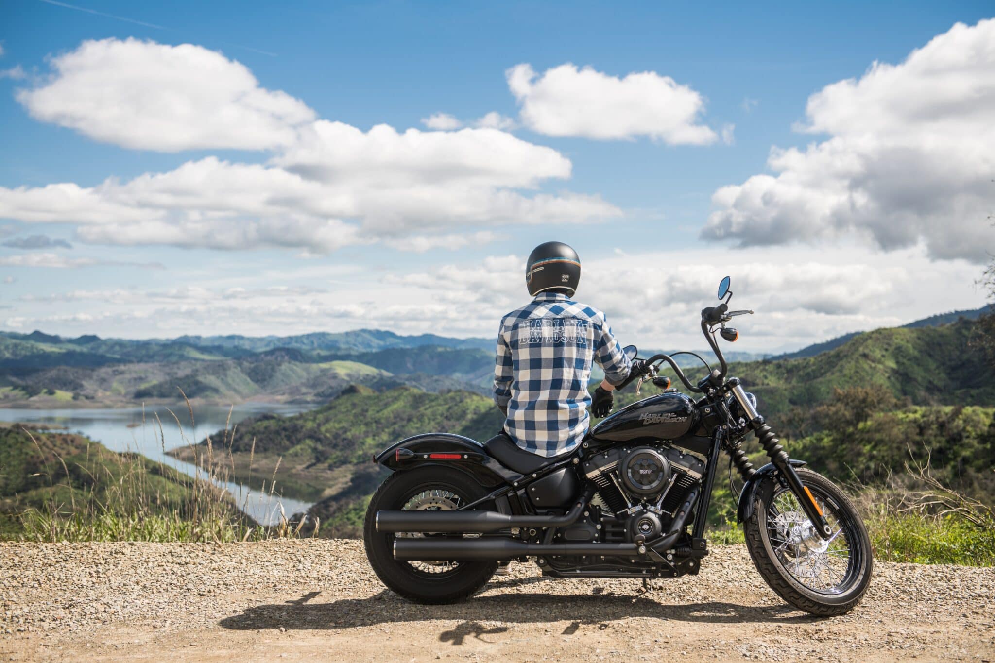 man-motorcycle-nature-hearing-loss-protection Man sitting on his motorcycle looking out at a beautiful view of nature.