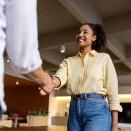 Woman shaking hands with her job interviewer