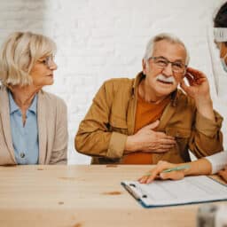 Man with hearing loss communicates with doctor