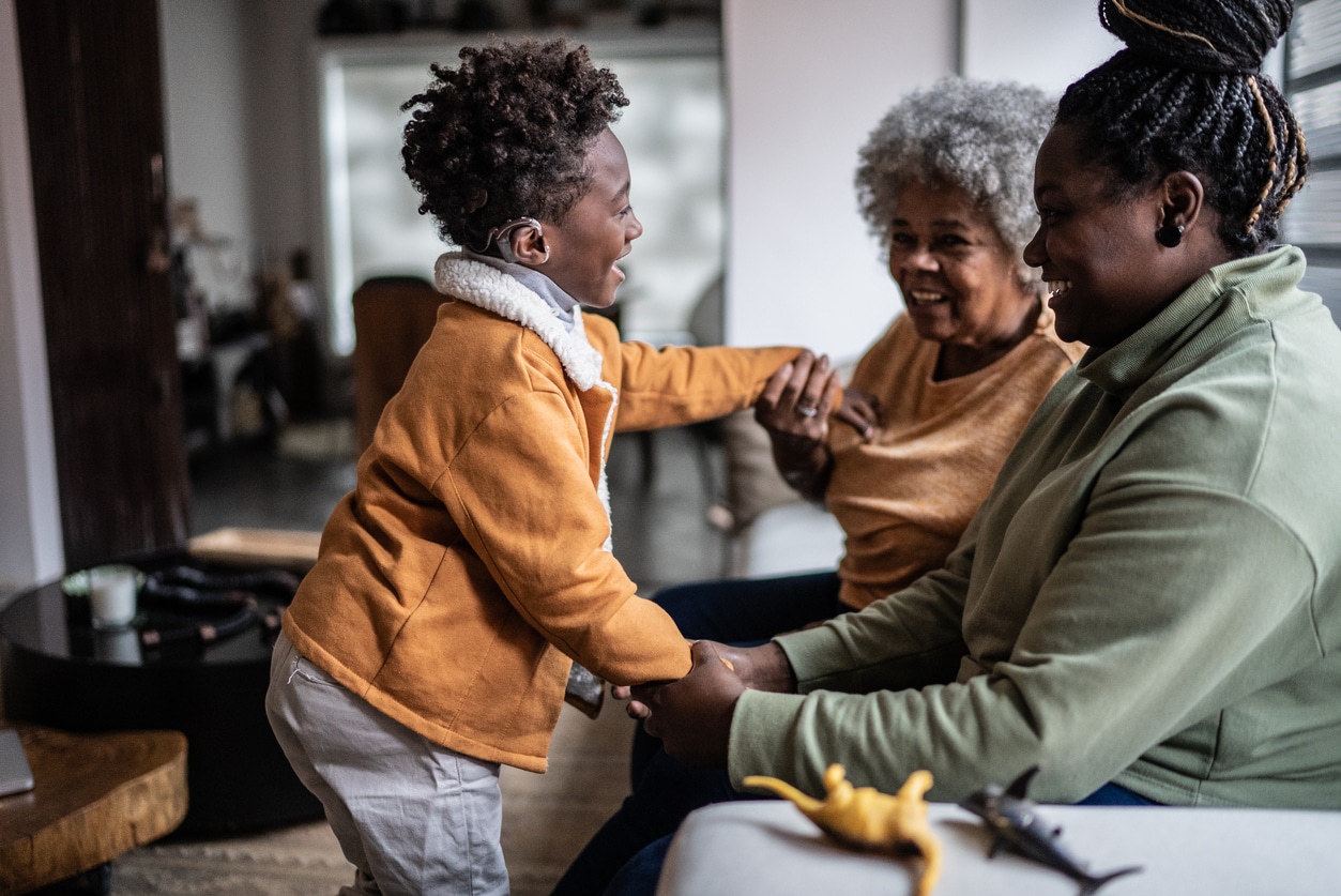 Boy with hearing loss interacts with family