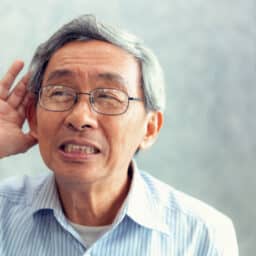 Man straining to hear something