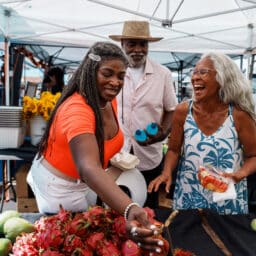 Three senior friends hanging out at a farmers market