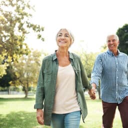 Happy couple going for a walk in the park.